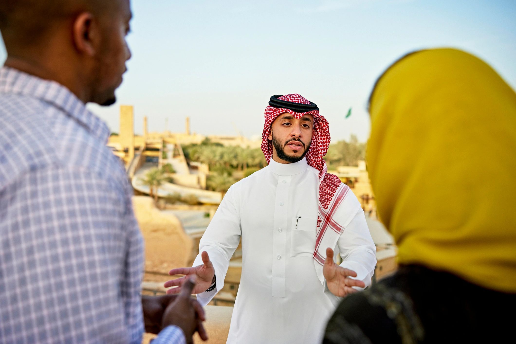 Travel guide speaking with visitors in a heritage setting