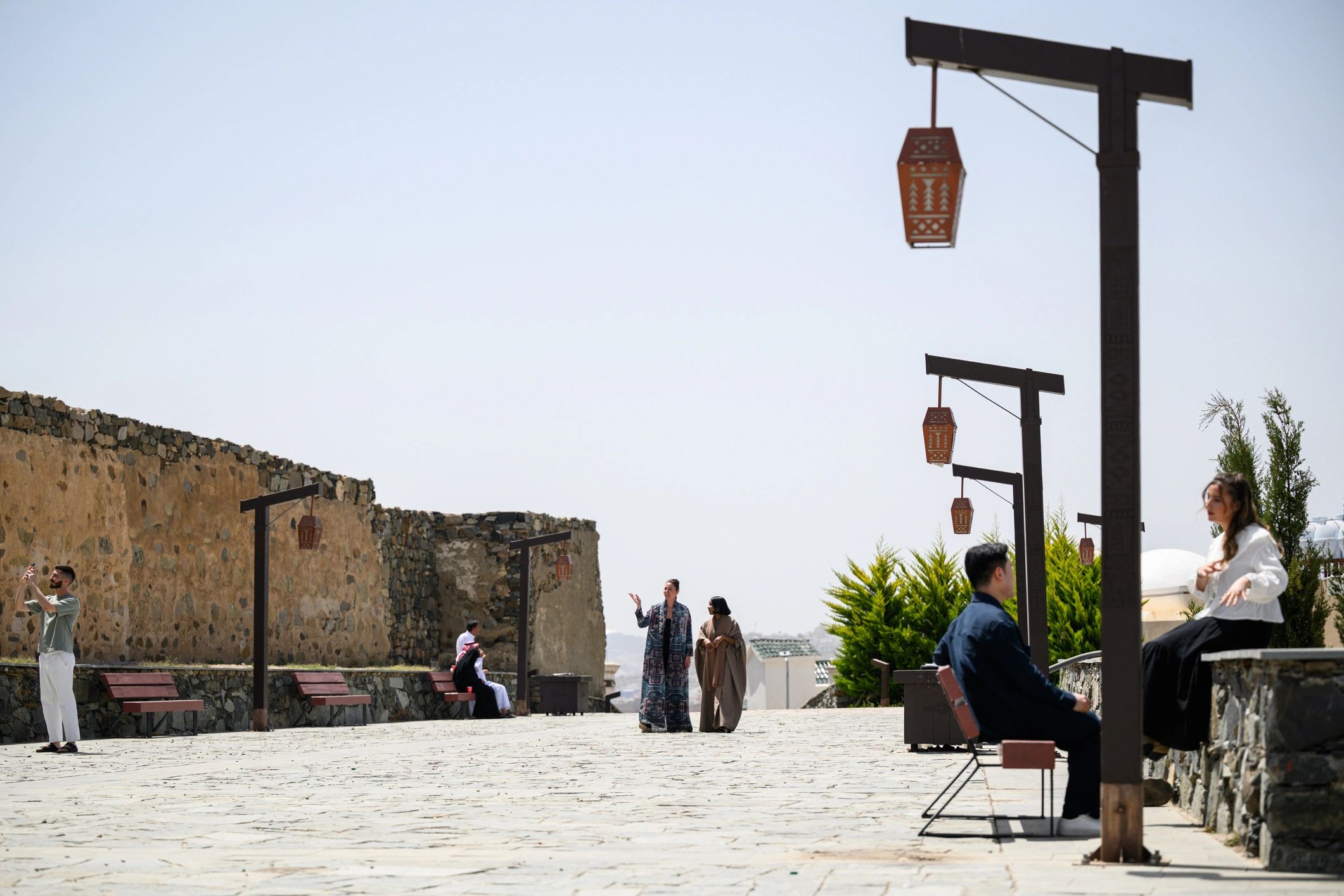 Travelers walking through a large courtyard